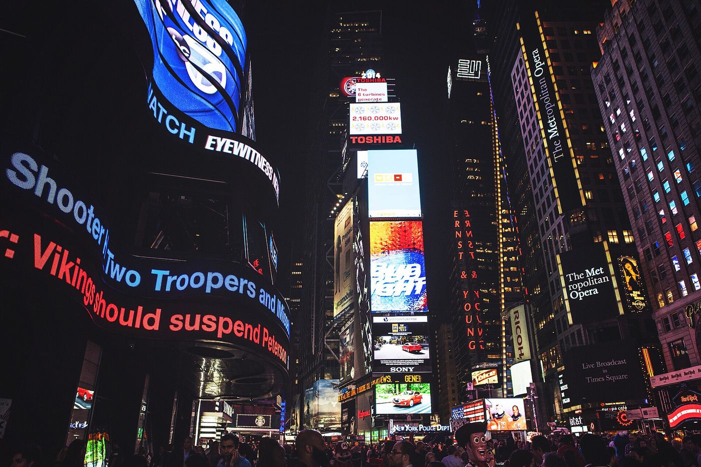 Theatre and restaurant signs lighting up Times Square, New York